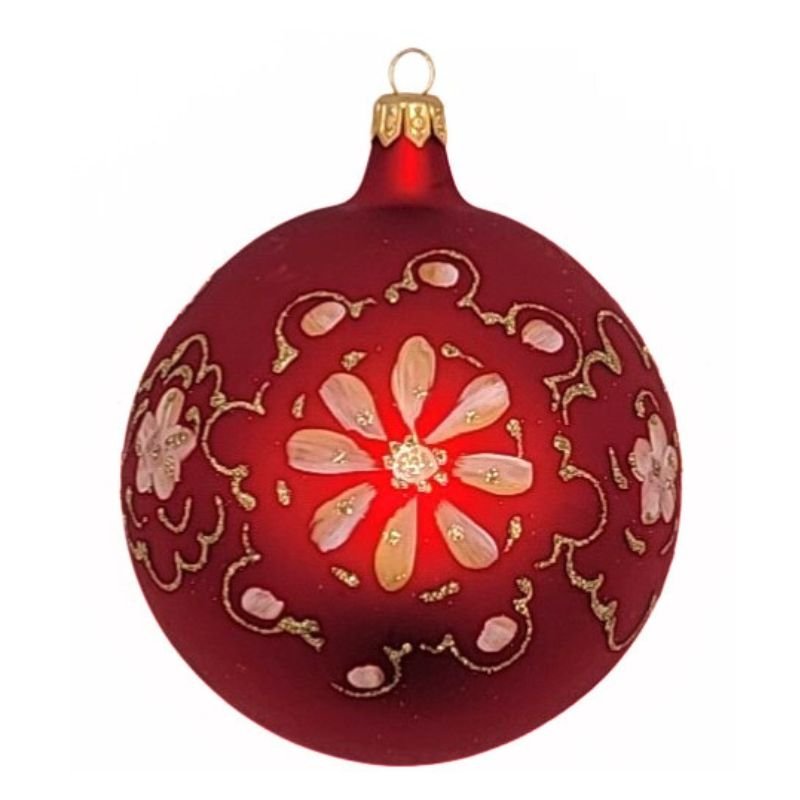 Blown glass ball ornament in matte red with a gold floral design  hand  painted  on it