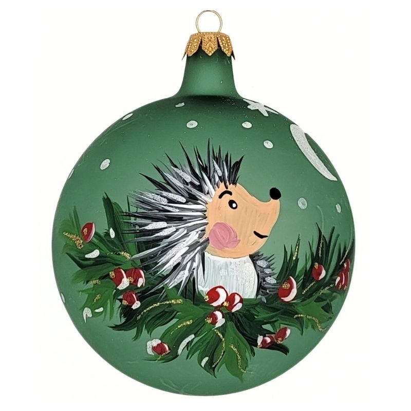 Blown glass ball ornament in matte green with a cute hedgehog on holly hand painted on it