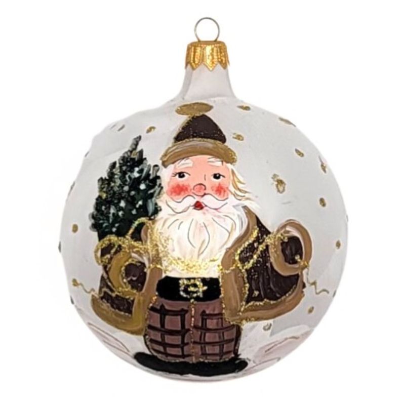 Blown glass ball ornament with a matte white textured background with a santa holding a small Christmas tree and gold polka dots hand  painted on it