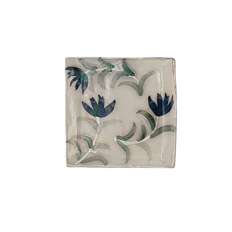"Hand-painted trinket dish with three blue flowers on a cream iridescent background, perfect for holding jewelry or small items"