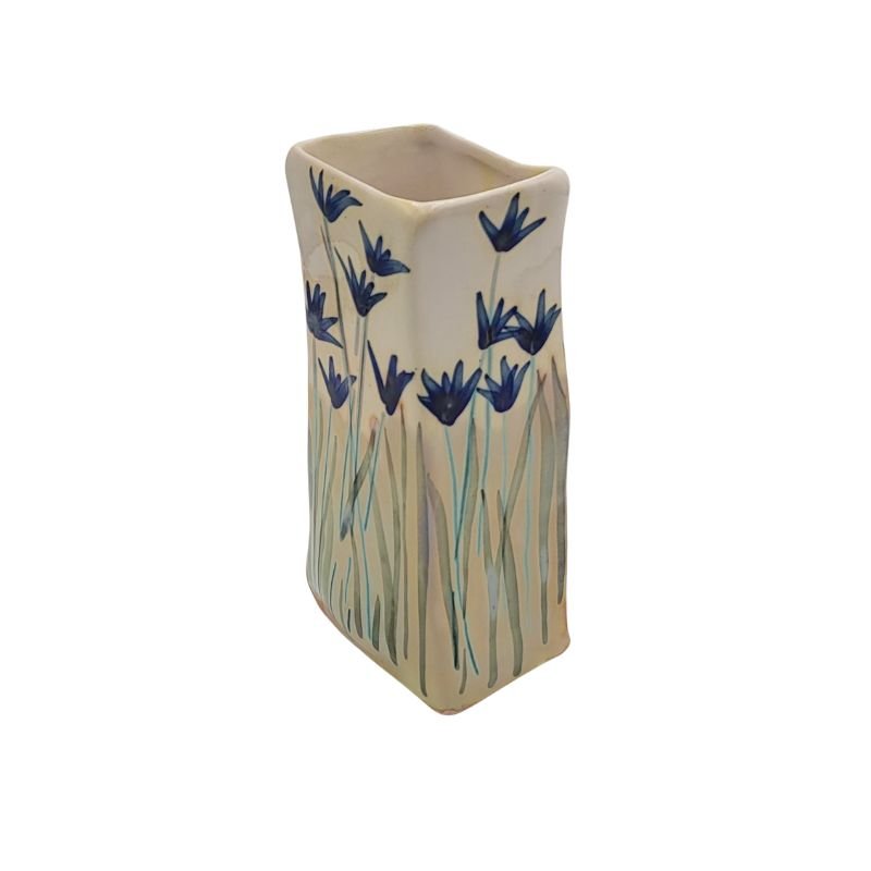 Rectangular vase with iridescent blue flowers.