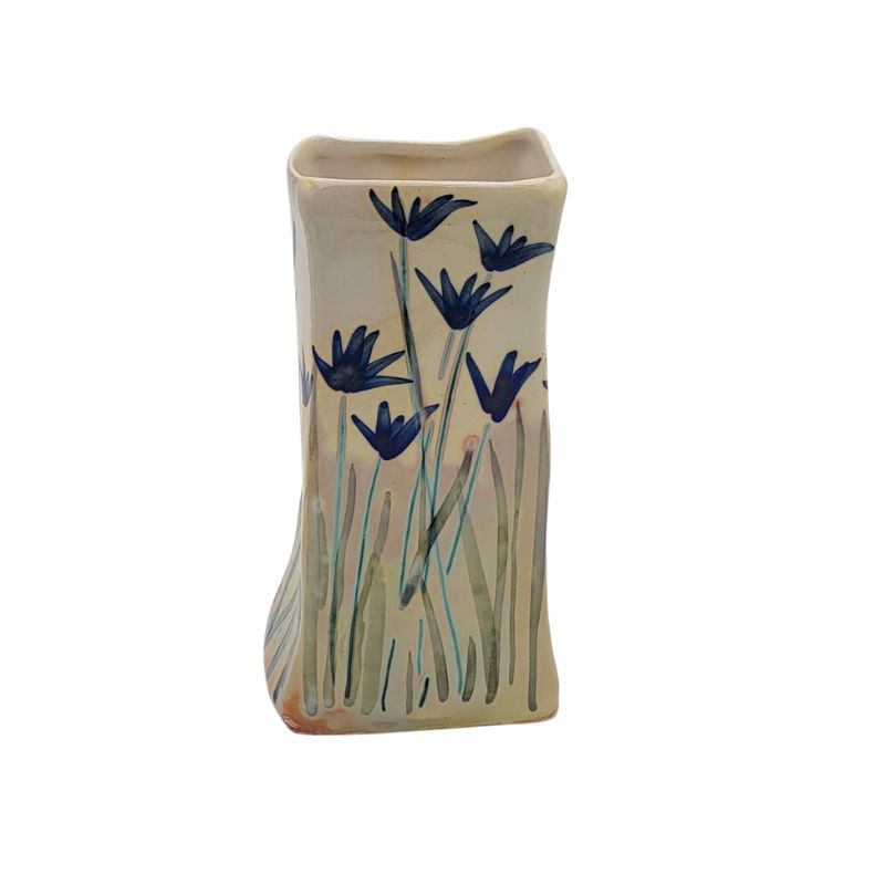 Rectangular vase with iridescent blue flowers.