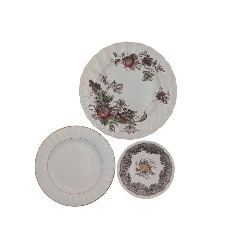 Three vintage china plates used to create a 3-tier serving stand with floral and gold detailing, handcrafted for elegant entertaining and home decor.