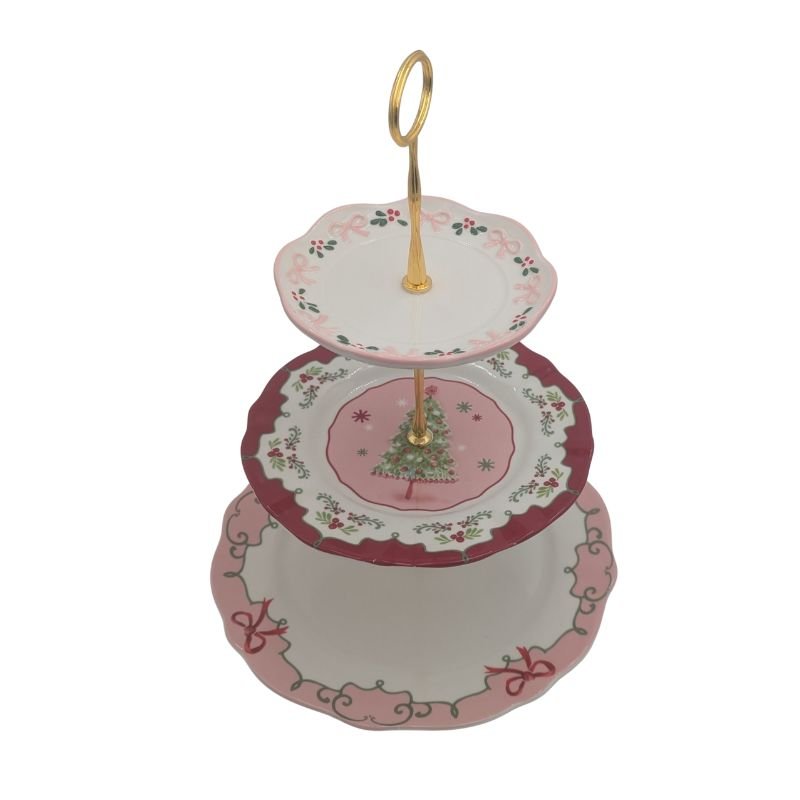 Three-tiered pink Christmas plate server with gold handle featuring holly, ribbon, and Christmas tree designs by Ardsley Barrett