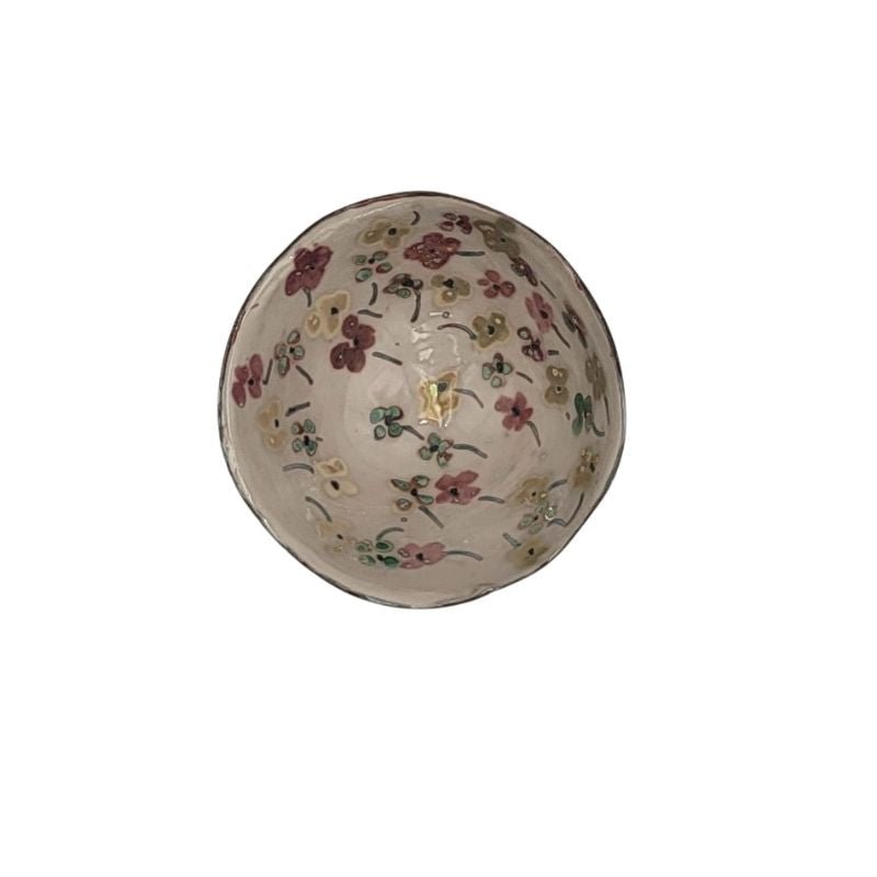 "Hand-painted iridescent bowl with small floral pattern, perfect for holding small items or as a decorative accent"