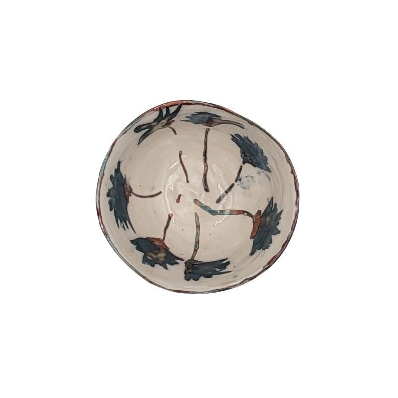 "Hand-painted iridescent bowl with large blue flowers, perfect for holding small items or as a decorative accent"