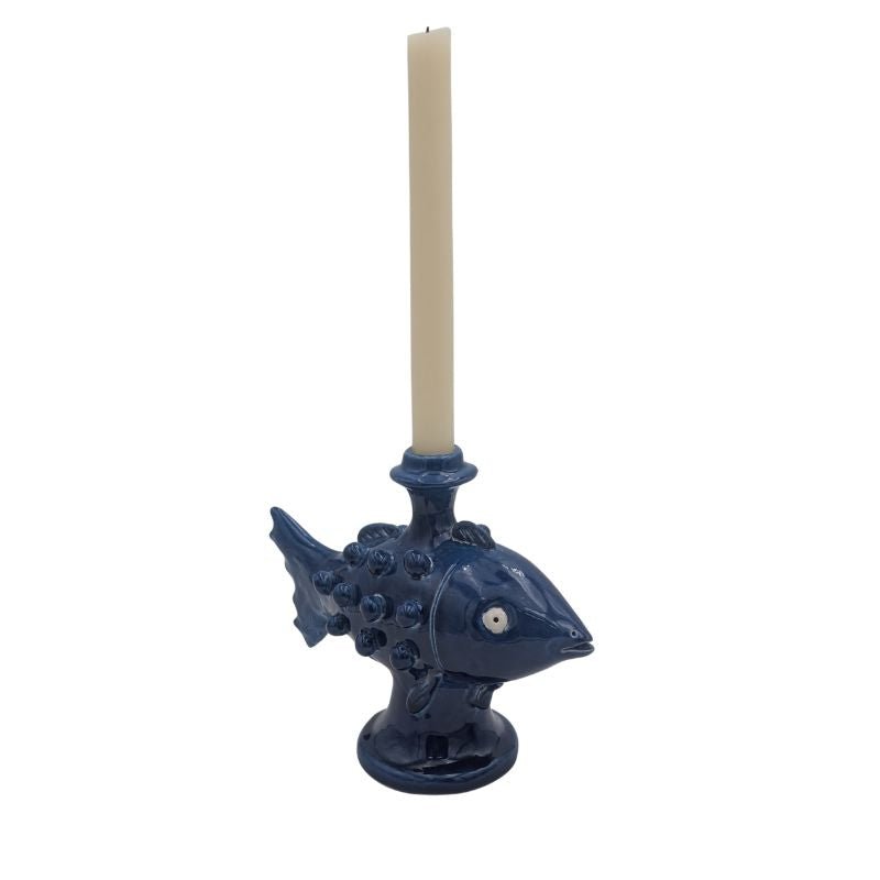 Handcrafted ceramic fish candle holder in blue, designed for taper candles.