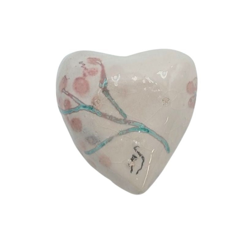 Handcrafted ceramic heart with blush cherry blossom design and teal branches, finished with an iridescent glaze.