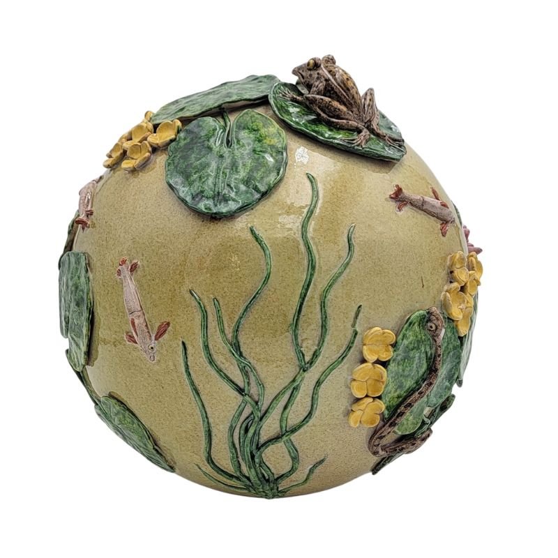 This light yellow ceramic sphere has a pond scene complete with frog, lily pads and koi.