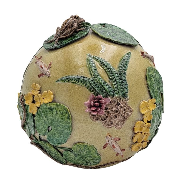 This light yellow ceramic sphere has a pond scene complete with frog, lily pads and koi.