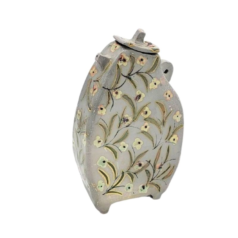 Decorative teapot hand painted with an iridescent small floral pattern.