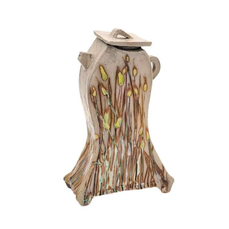 Deccorative hand painted teapot with iridescent wildflowers painted on it.