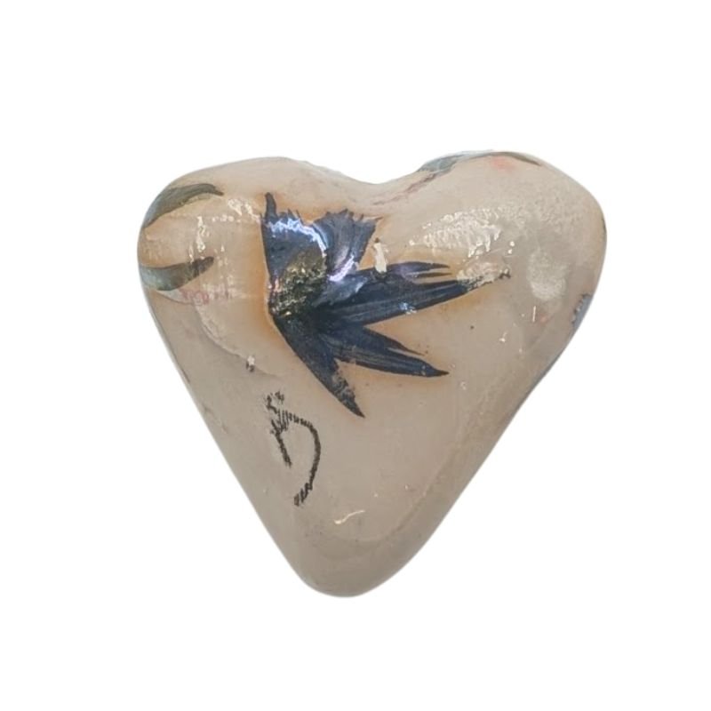 Handcrafted ceramic heart with soft green and purple floral design and iridescent glaze, one-of-a-kind decorative art piece.