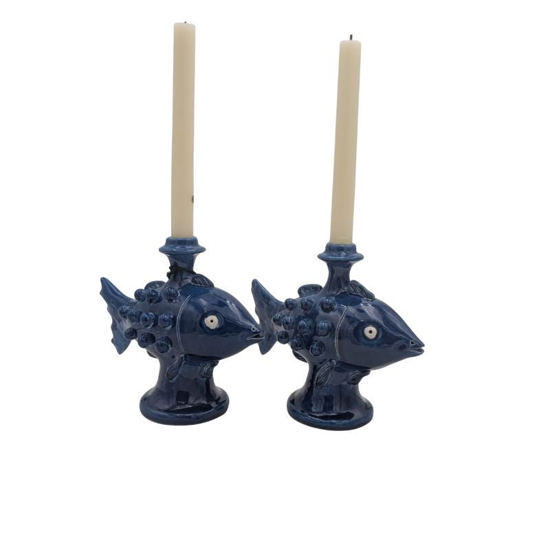 Handcrafted ceramic fish candle holder in blue glaze, designed for taper candles.