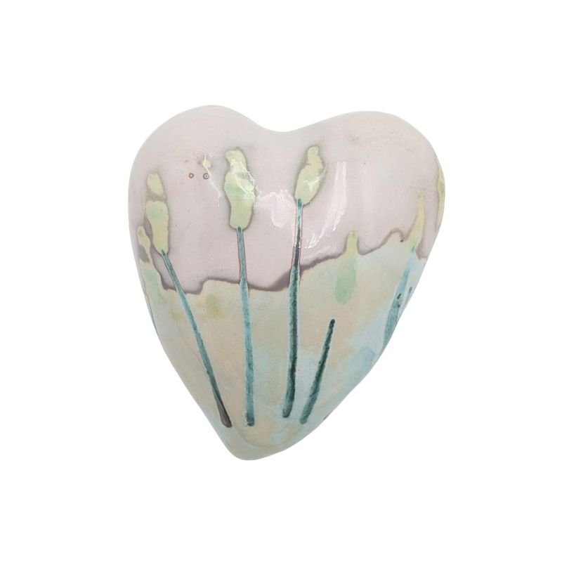 Ceramic heart with soft pastel floral stems in mint, aqua, and yellow tones, finished with an iridescent glaze by Paola Staccioli.