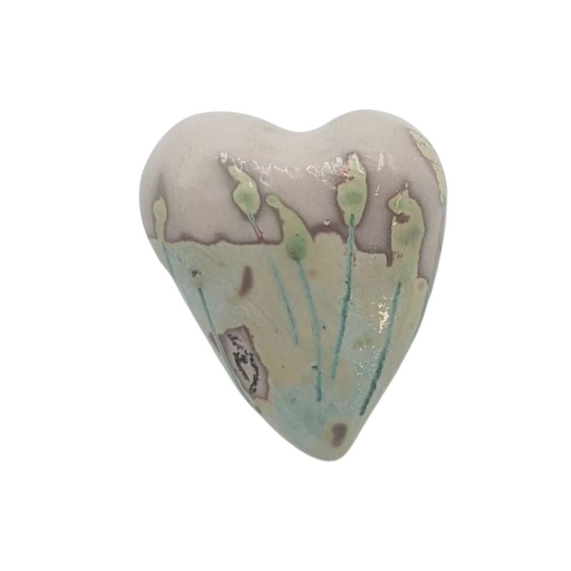 Ceramic heart with soft pastel floral stems in mint, aqua, and yellow tones, finished with an iridescent glaze by Paola Staccioli.