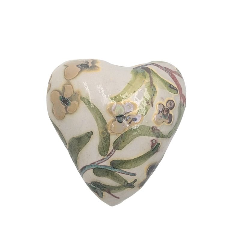 Ceramic heart with soft floral design in yellow and plum, finished with an iridescent glaze by Paola Staccioli.