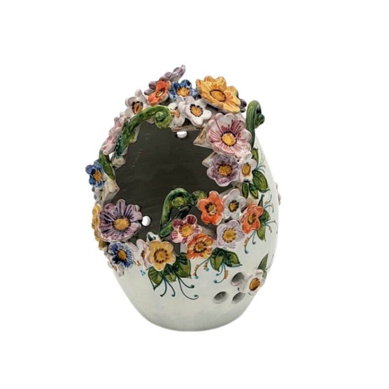 Ceramic egg with multi colored three dimensional flowers on it