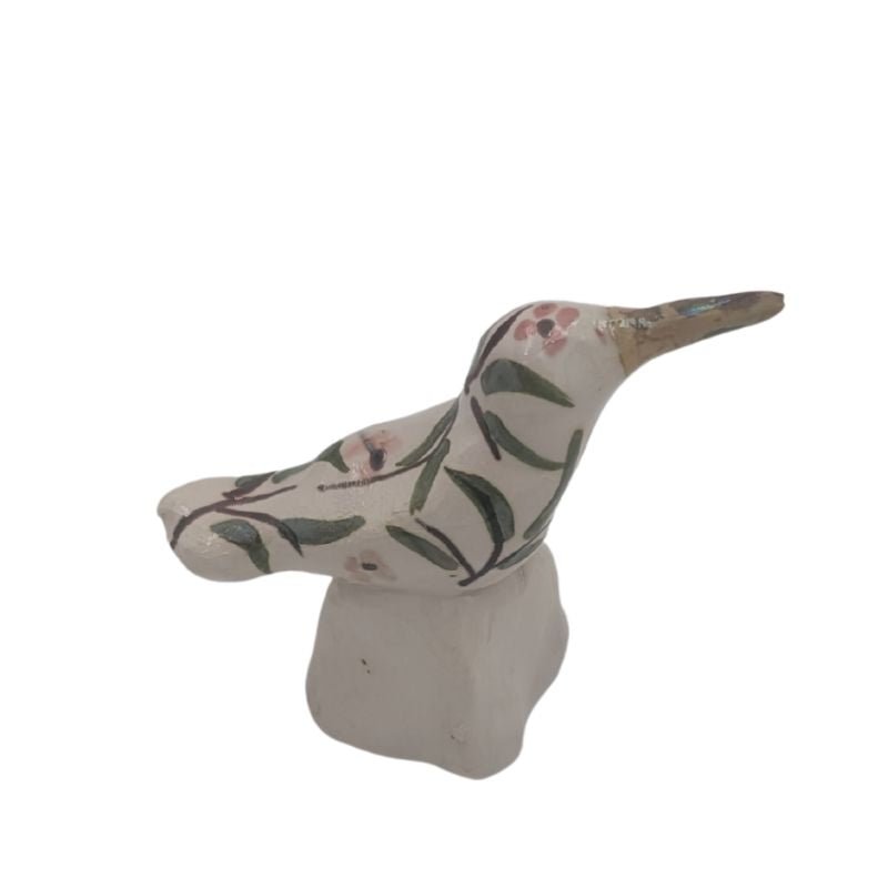 Handcrafted hummingbird figurine with soft pink floral pattern and iridescent glaze, one-of-a-kind art piece for bookshelf or tabletop display.