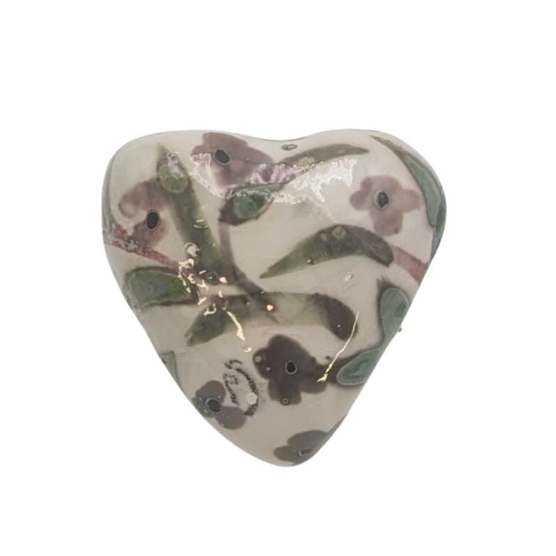 Handcrafted ceramic heart with soft green and plum leaf and blossom design, finished with a subtle iridescent glaze.