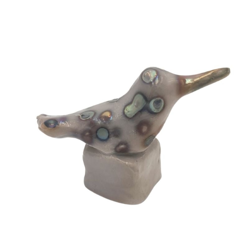 Hand painted hummingbird figurine with an iridescent dog pattern.