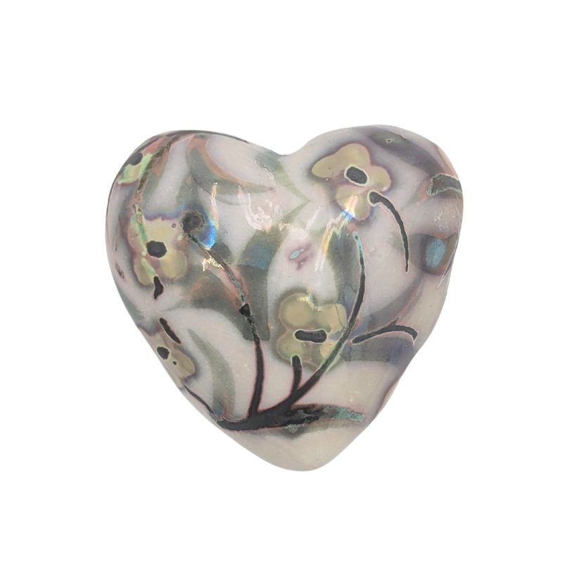 Ceramic heart with soft floral design in yellow, green, and pops of turquoise, finished with an iridescent glaze by Paola Staccioli.