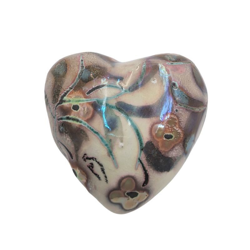 Ceramic heart with soft floral design in yellow, green, and pops of turquoise, finished with an iridescent glaze by Paola Staccioli.